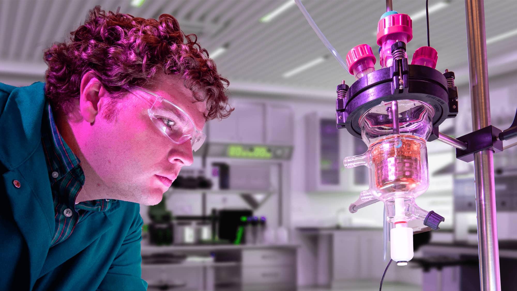 Male student wearing protective goggles in a VCU science laboratory